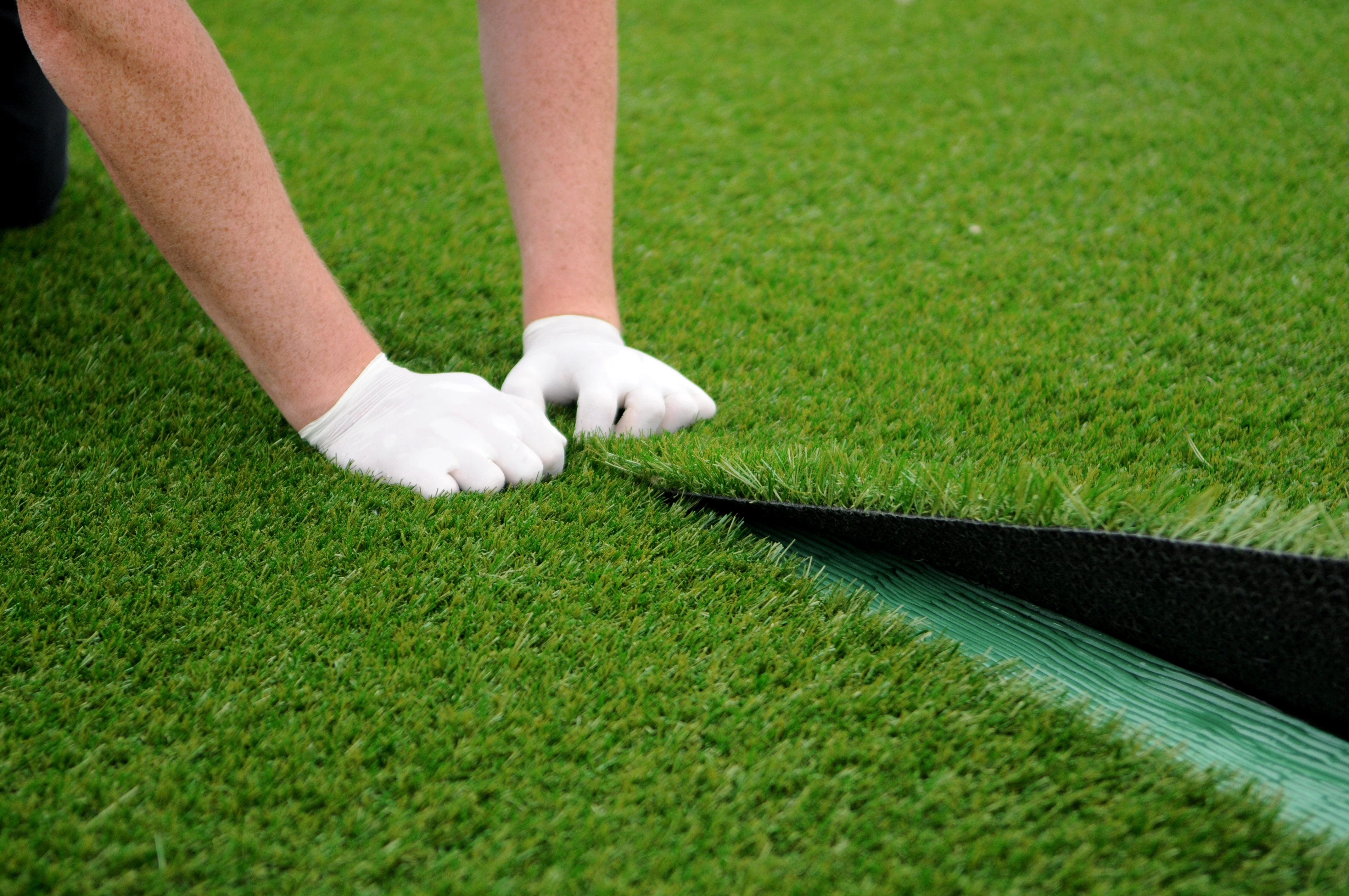 Fixing The Seams Of The Turf Together.webp